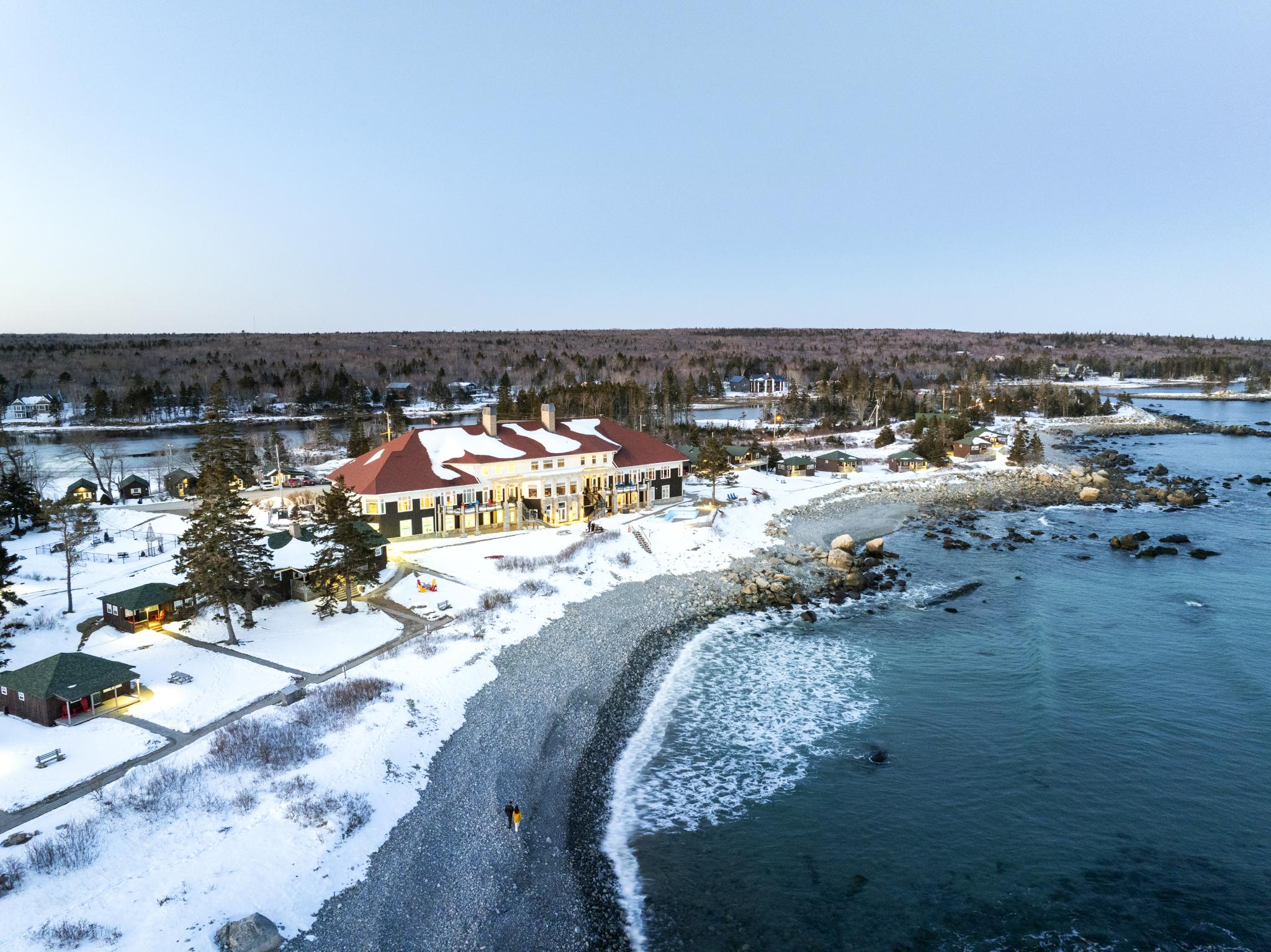 An aerial shot of White Point Beach Resort and the beach and shoreline in front of the resort during winter.
