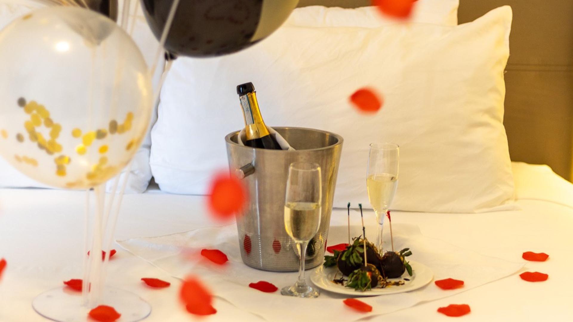 Anniversary balloons and confetti with a bucket of champagne on ice with two glasses at Digby Pines