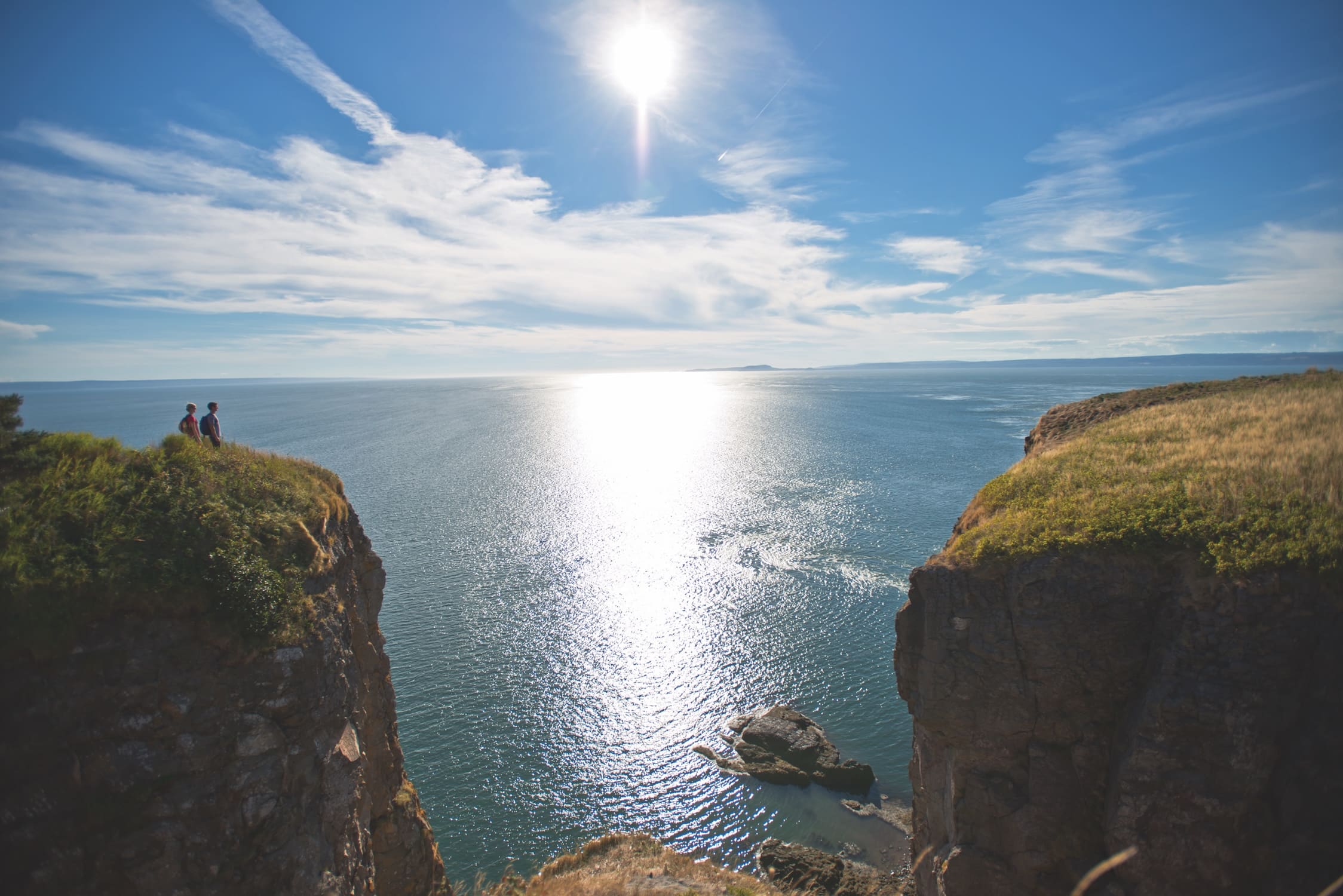 Two hikers enjoy Cape Split on a beautiful blue sky, sunny day