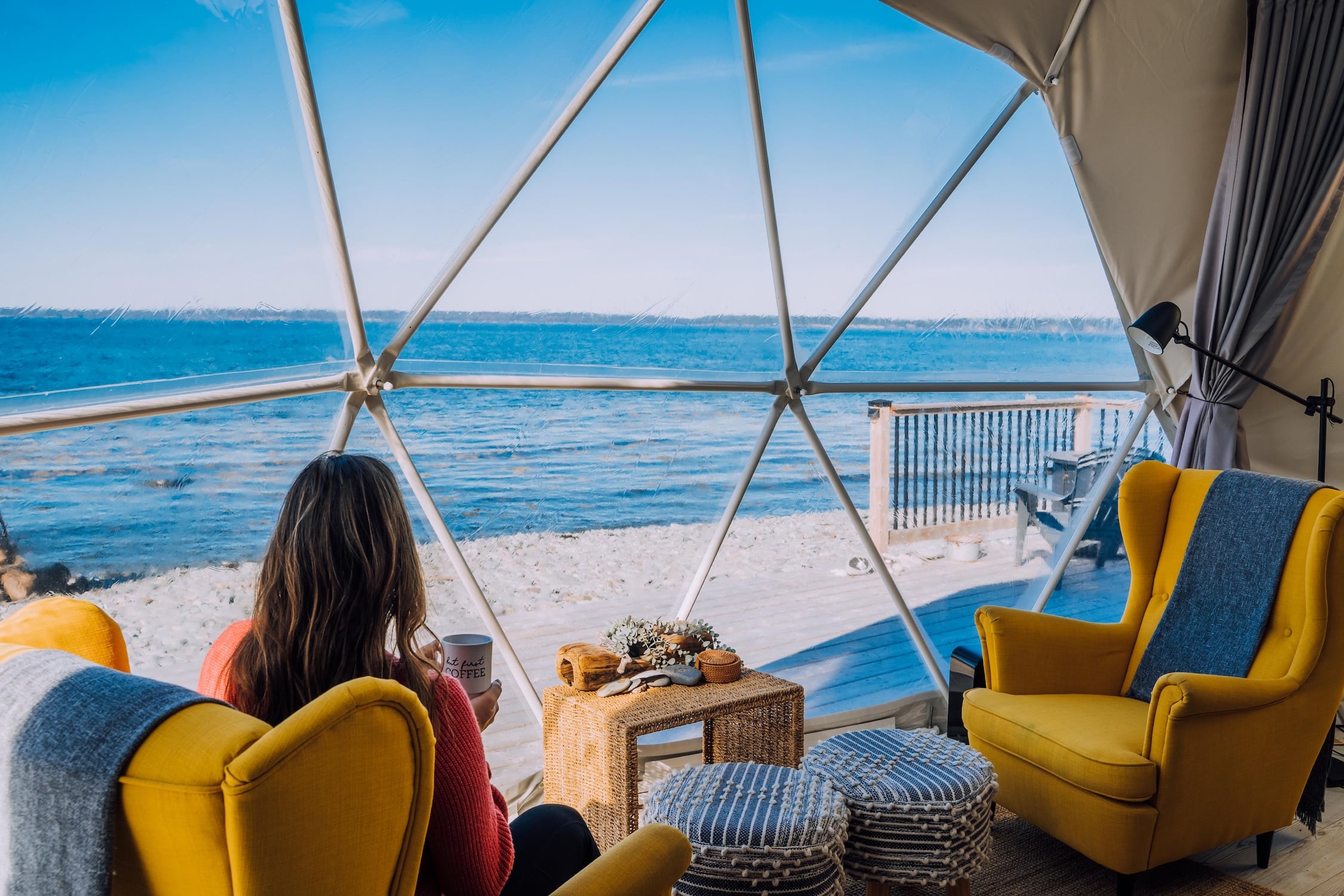 Woman sitting in a yellow chair in a dome