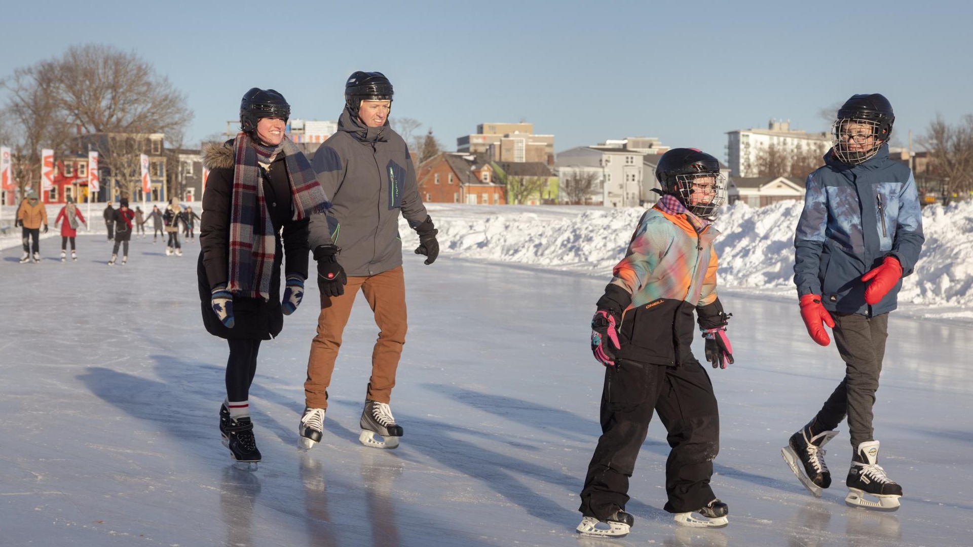 A family is ice skating on the Emera Oval in Halifax