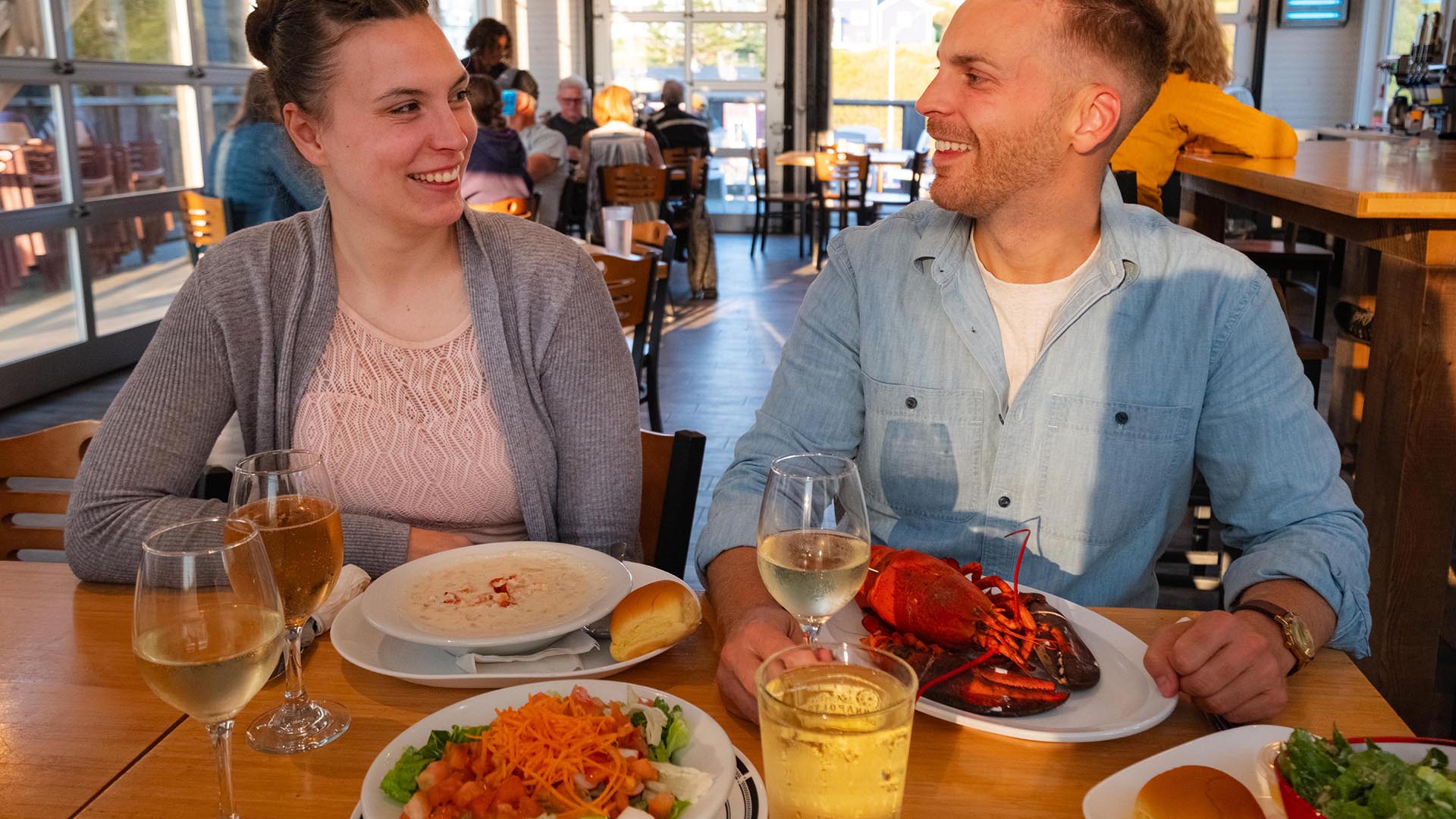 Two people enjoying their meal at Hall's Harbour Lobster Pound and Restaurant