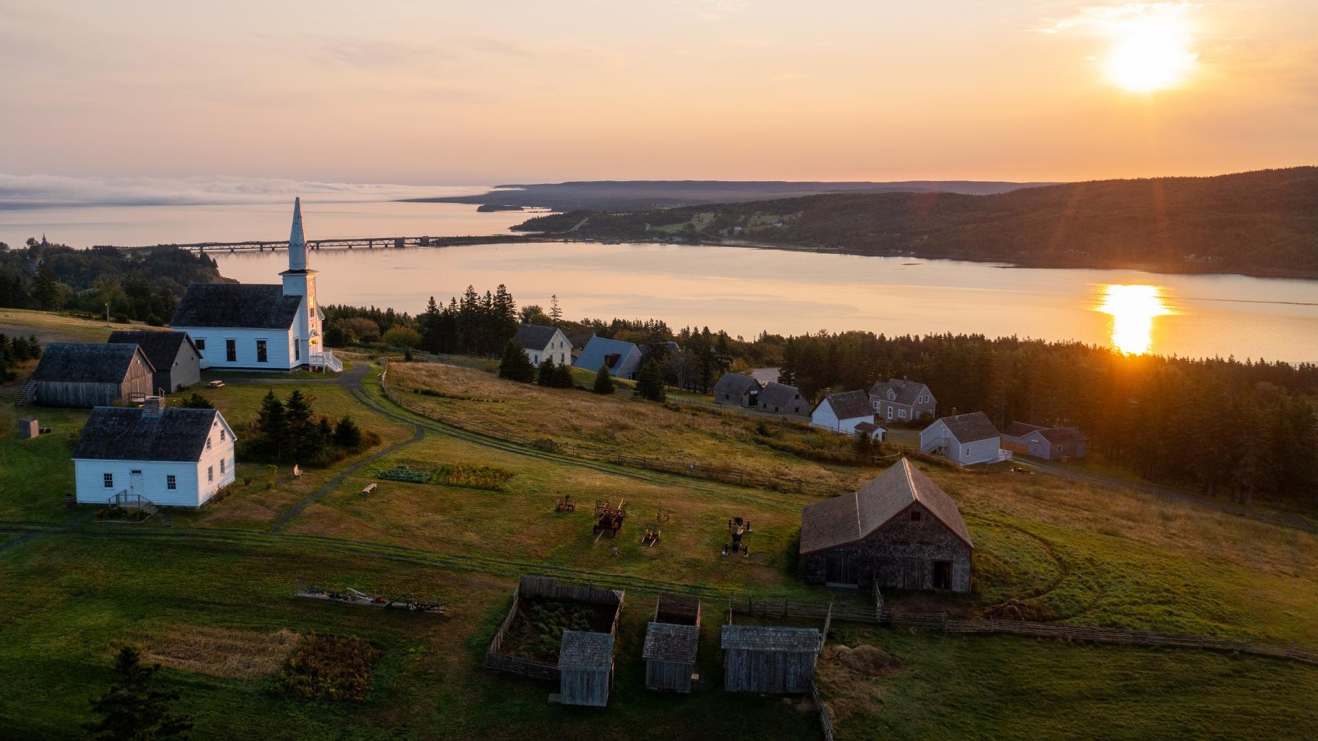 An aerial view of a living history museum at sunset.