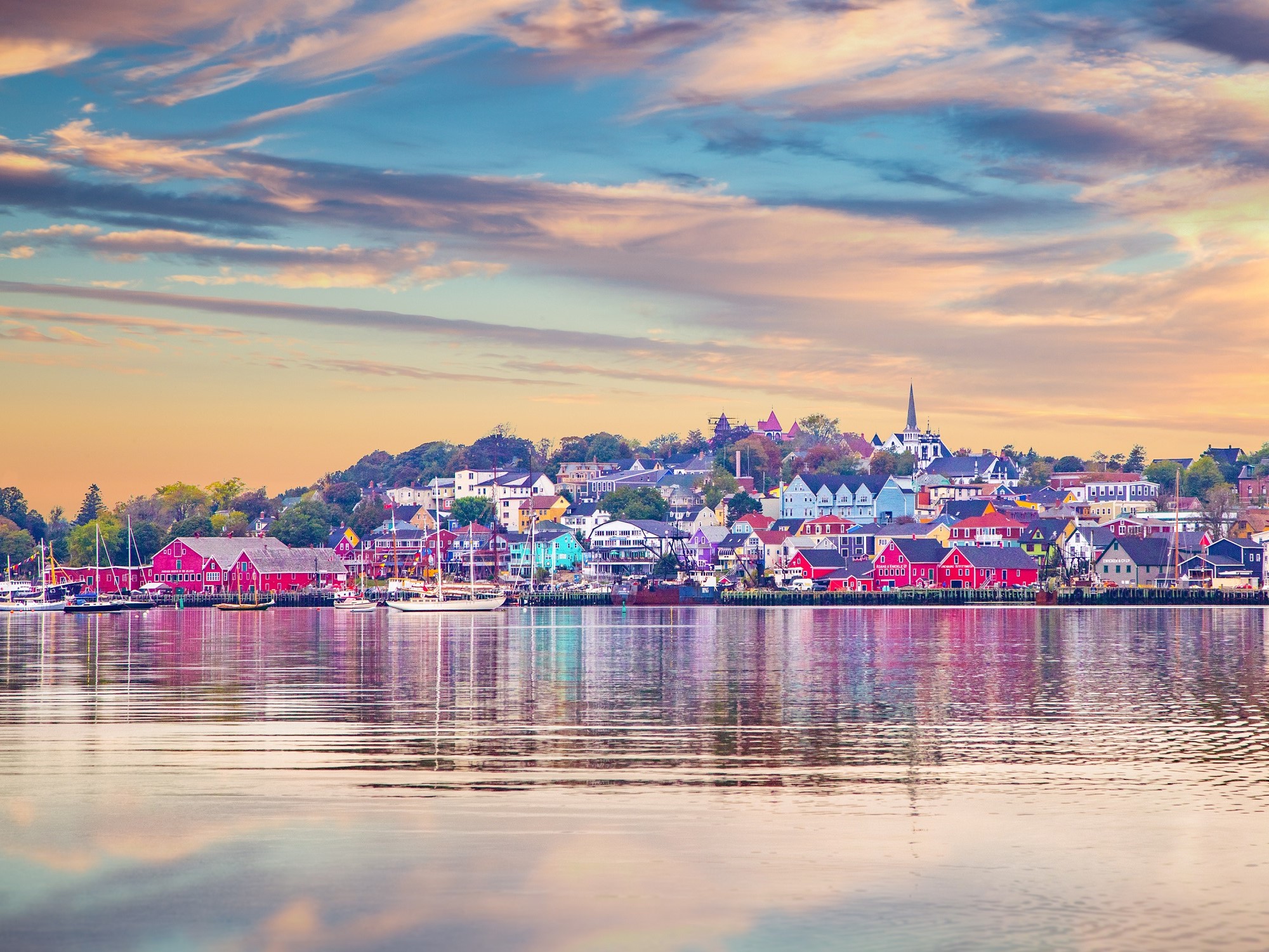 View across the harbour of a colourful coastal community