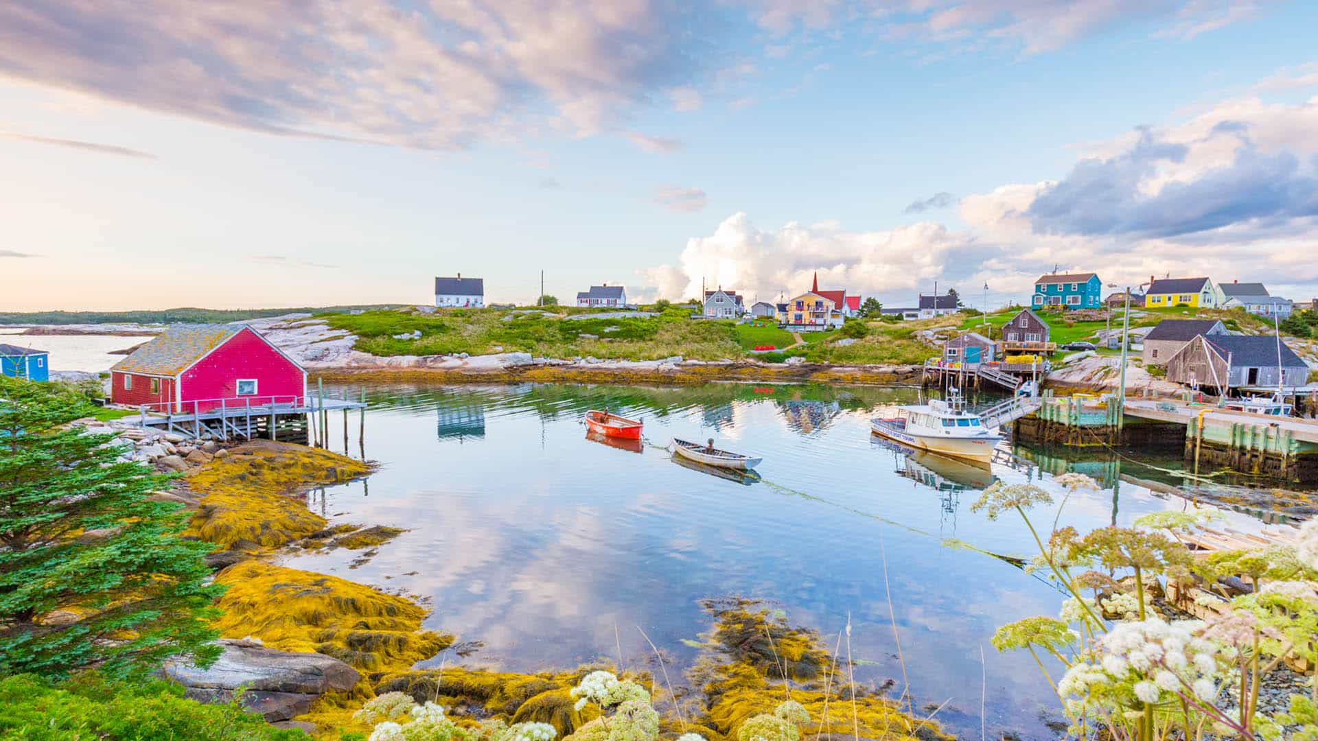 Peggy's Cove Village with colourful houses and tiny boats in the harbour