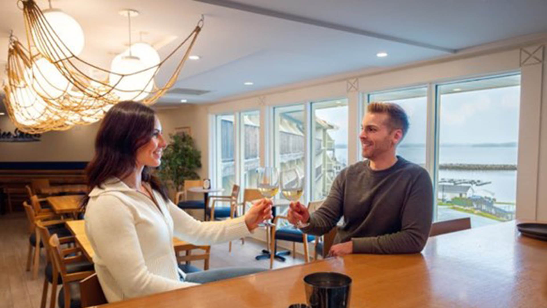 Two people enjoying a glass of wine at Oak Island Resort and Conference Centre