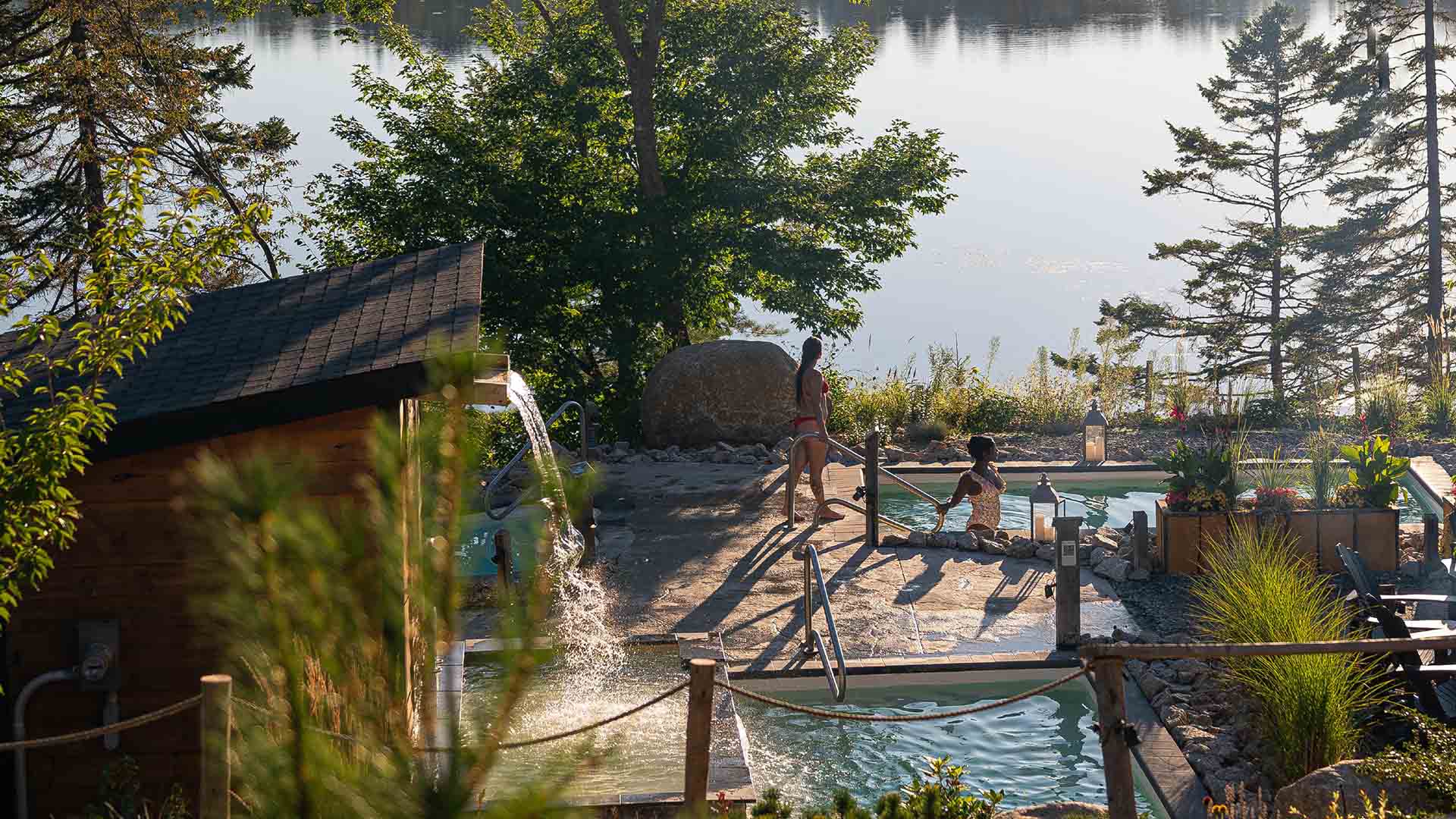 Friends experiencing the hot and cold pools at Sensea Nordic Spa on a sunny day in Nova Scotia