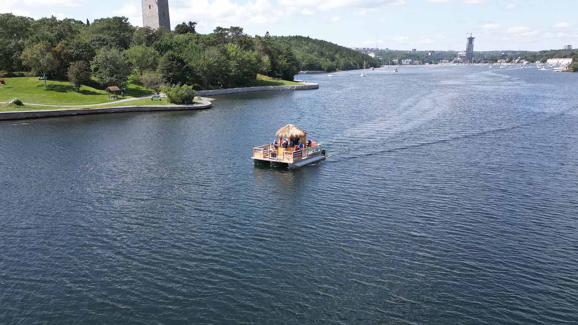 A drone shot over the Northwest Arm of a Tiki Tours Halifax boat cruise in Halifax, Nova Scotia