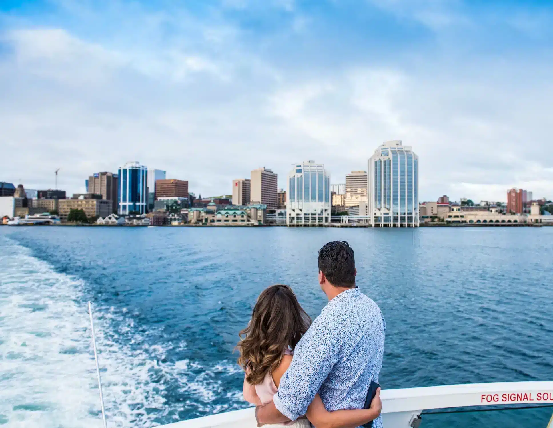 Couple on the ferry looking back at Halifax Waterfront