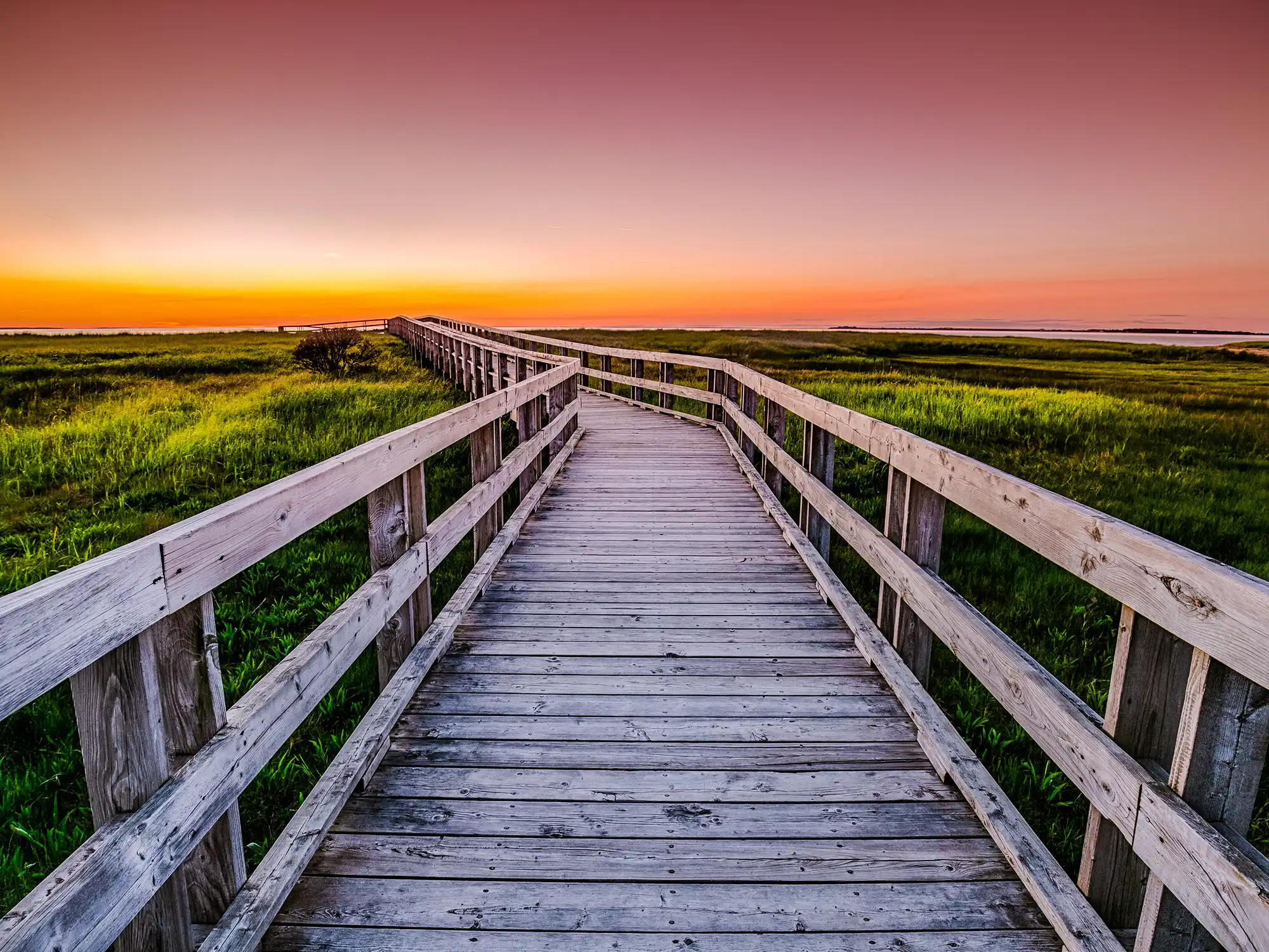 The wooden boardwalk to Rushton's Beach at Sunset