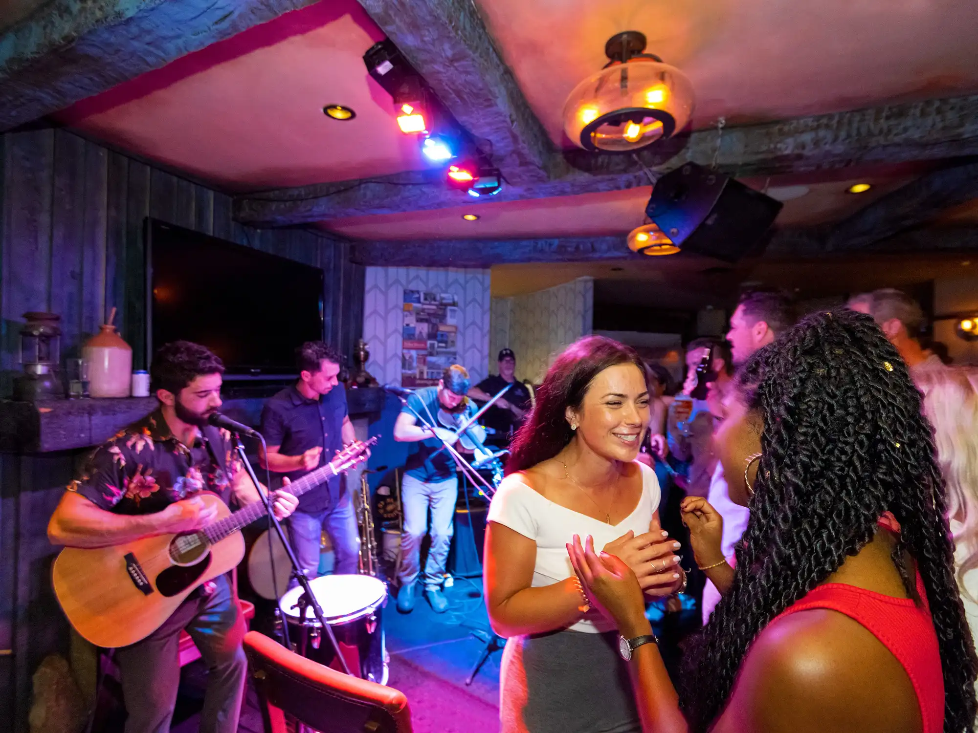 Two people interact in front of a band at Dirty Nelly's Pub in Halifax