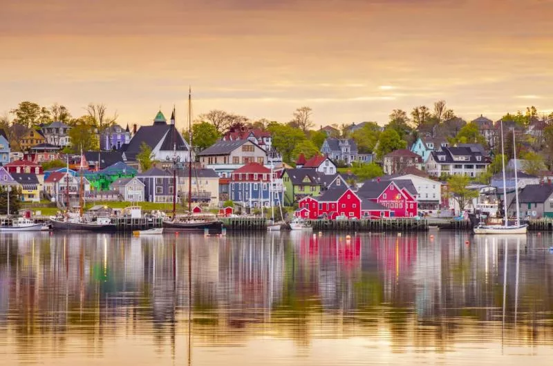 View of the Lunenburg Waterfront with colorful buildings and sailboats in the harbor.