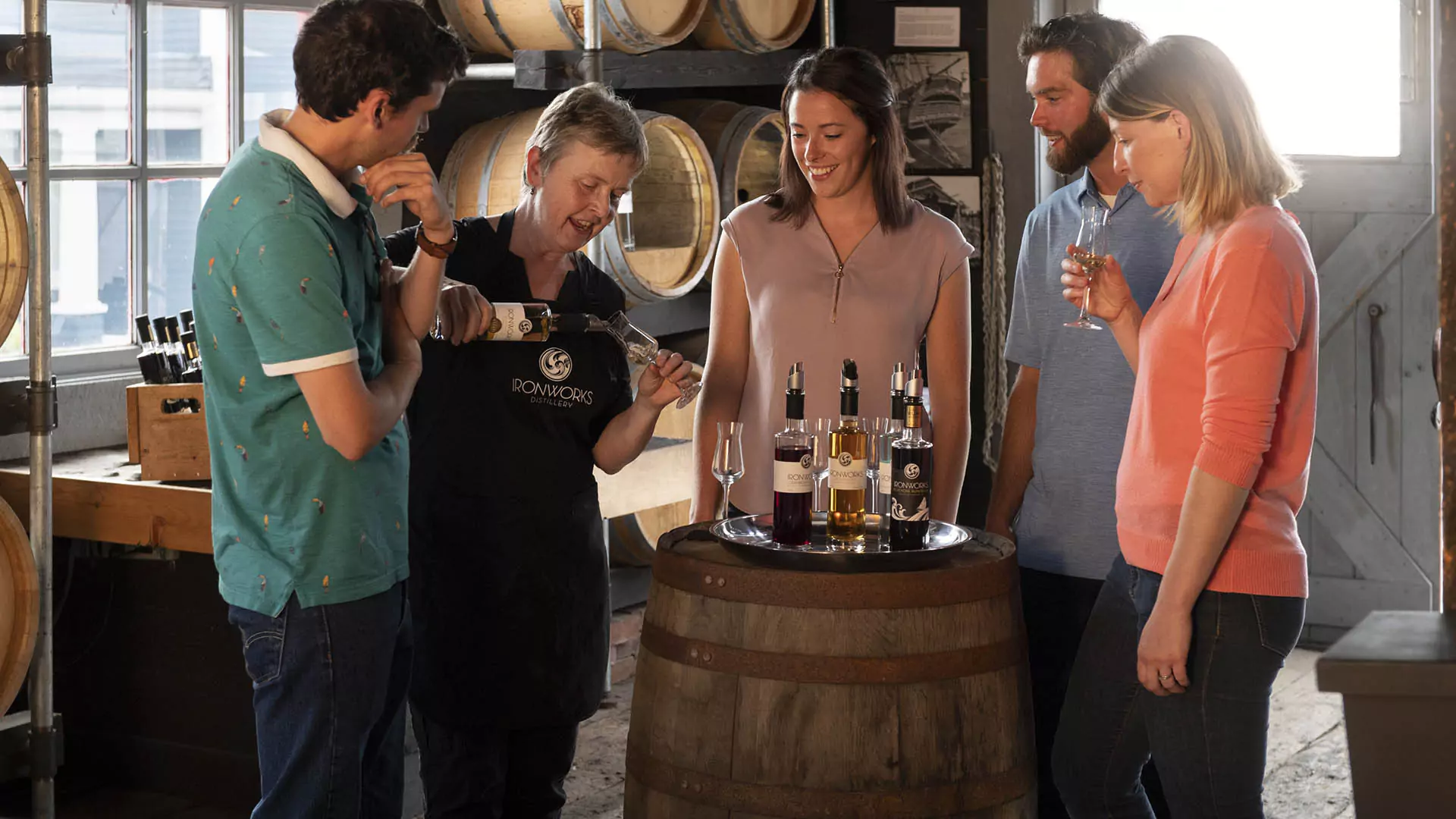 A group of visitors try Ironworks products at the distillery