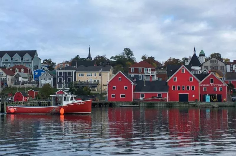 View of the Lunenburg Waterfront with colorful buildings and sailboats in the harbor.