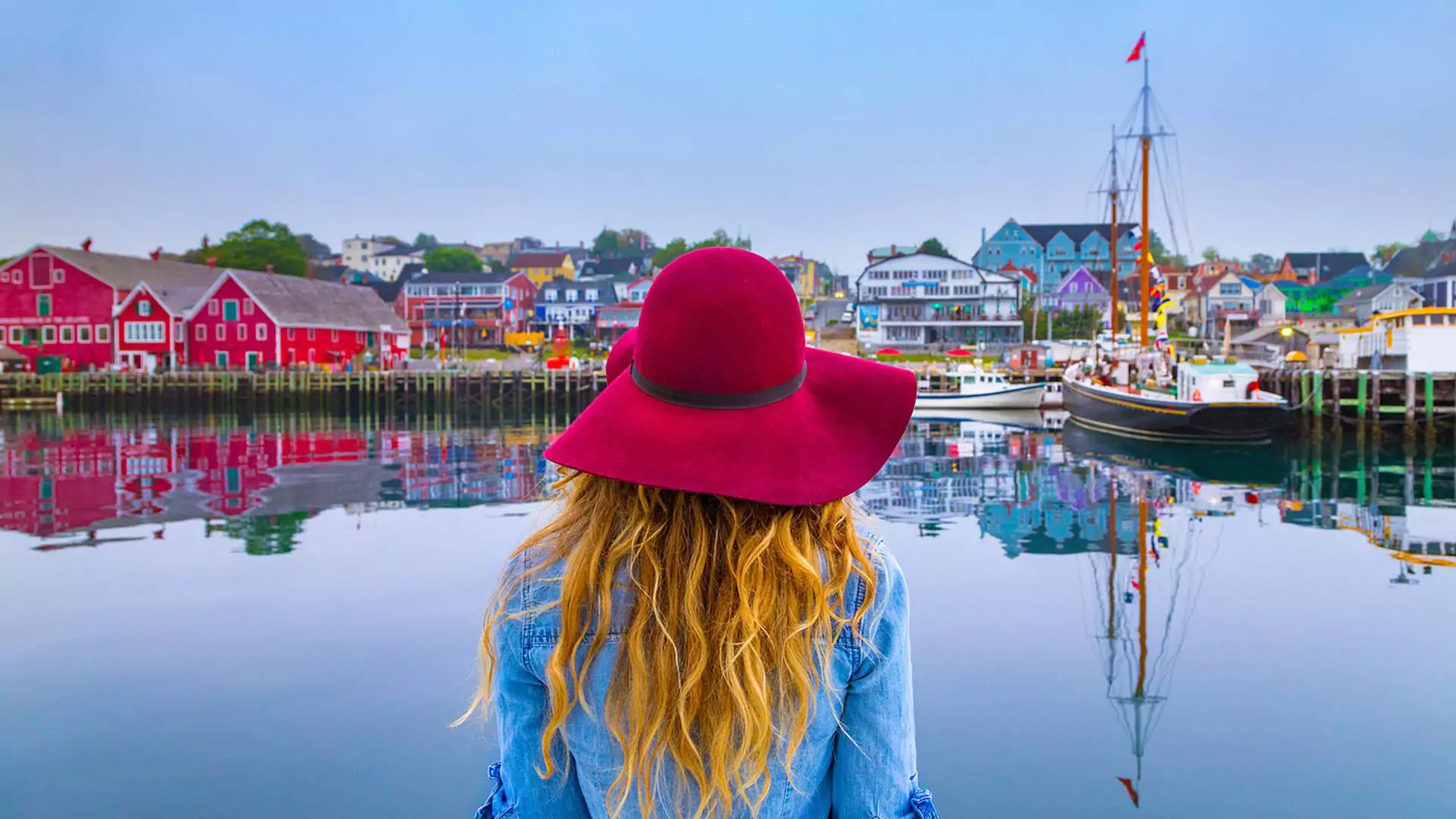 Lady in a red hat enjoys the view of the Lunenburg Waterfront