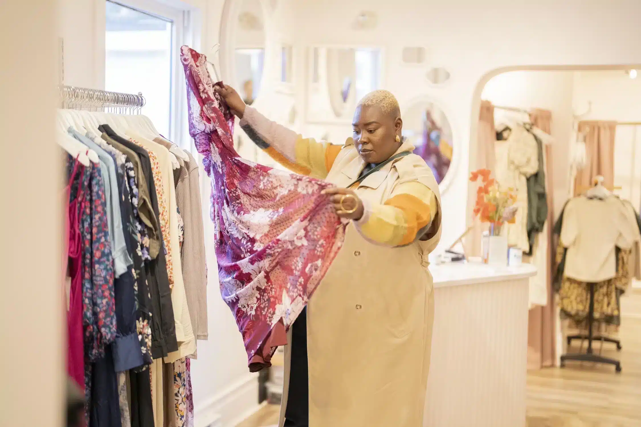 Lady looks at pretty dress while shopping in Downtown Halifax