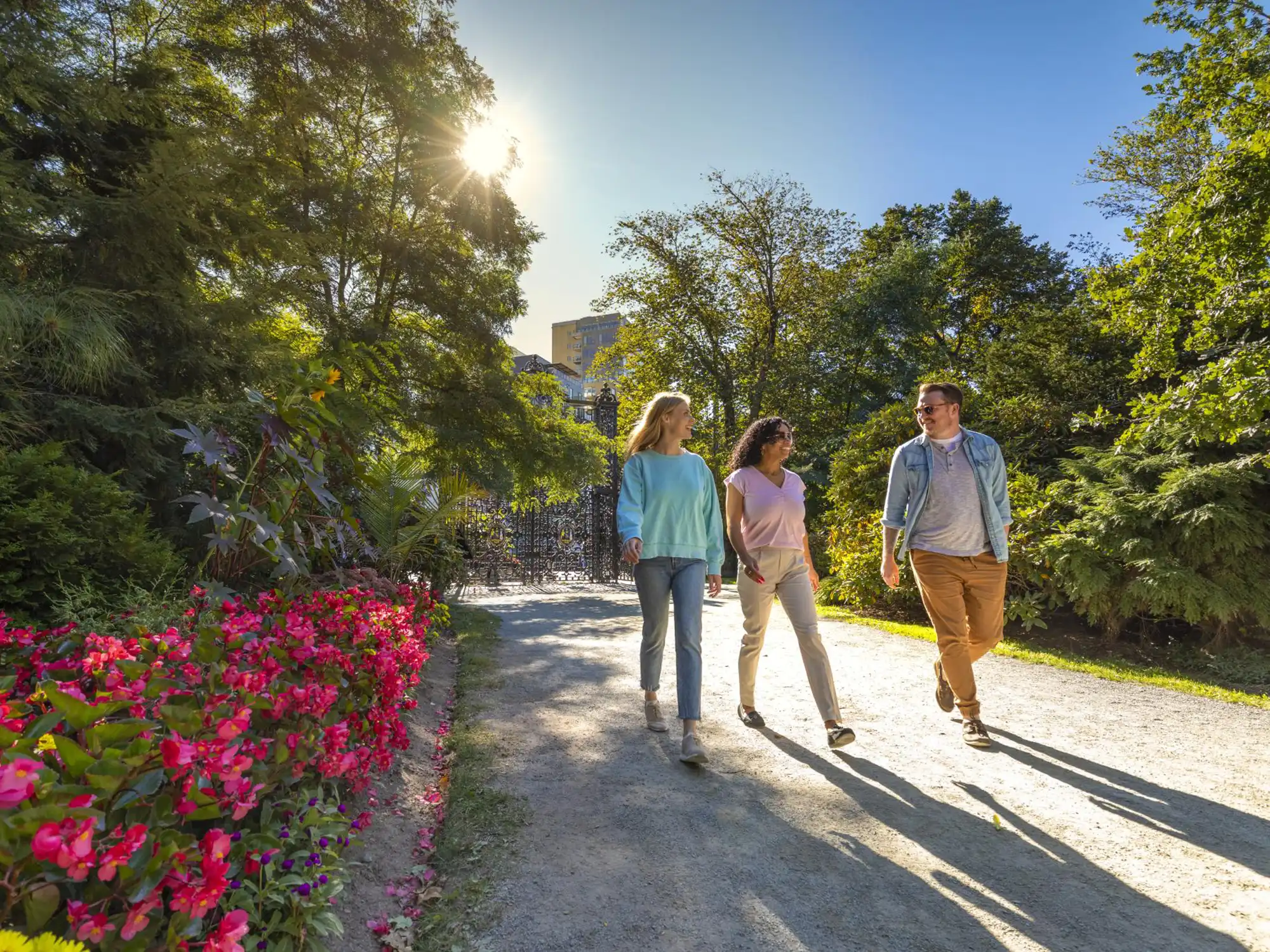 A group of people walk out into the Halifax Public Gardens